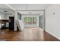 Open living area with hardwood floors, large windows, and natural light at 397 Campground Rd, Mcdonough, GA 30253