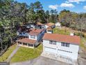 Aerial view of a multi-building property, featuring large lawn and mature trees at 387 Colvin Dr, Locust Grove, GA 30248