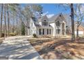 Exterior view of stucco home showing driveway and partial side view at 407 Blue Smoke Trl, Peachtree City, GA 30269
