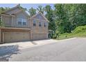 A two-story townhome features a brick facade, siding accents, a well-kept lawn, and an attached two-car garage at 2333 White Oak Se Bnd, Smyrna, GA 30080