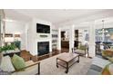 Bright living room showcasing a fireplace, wood floors, and seamlessly connecting to the kitchen and dining areas at 2333 White Oak Se Bnd, Smyrna, GA 30080
