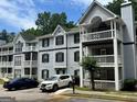 Apartment building with gray siding, black shutters, and white trim, complemented by well-maintained landscaping at 3480 Shepherds Path, Decatur, GA 30034