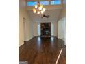 Open living space with a stone fireplace, vaulted ceilings, and hardwood floors at 1725 Sara Se Ct, Conyers, GA 30013