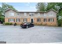Apartment building shows brick and wood siding with parking spaces at 3626 Buford # C1, Brookhaven, GA 30329