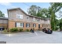 Apartment building shows brick and wood siding with a large parking lot at 3626 Buford # C1, Brookhaven, GA 30329