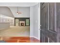 View of a living room with a fireplace and a ceiling fan, bathed in natural light at 85 Parks Pl, Sharpsburg, GA 30277
