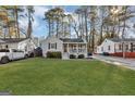 Charming single-story home with a well-maintained lawn and inviting front porch with white railings at 2912 Palm, East Point, GA 30344