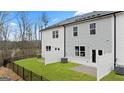 Private backyard with a manicured lawn and a fence offering serene outdoor living at 318 Sound Circle, Stockbridge, GA 30281