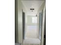 Hallway leading to room with ceiling fan and large window, showcasing bright and open space at 8035 Buffet, Riverdale, GA 30296