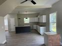 Kitchen with recessed lighting, modern island, stainless appliances, and wood plank flooring at 8035 Buffet, Riverdale, GA 30296