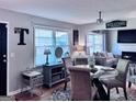 Light-filled dining area with a glass table and views into the comfortable living room, perfect for entertaining at 107 Woodhaven Dr, Stockbridge, GA 30281