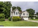 Charming two-story home with well-maintained lawn, mature trees, and a two-car garage at 639 Sheffield Ct, Villa Rica, GA 30180