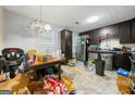 The kitchen features dark cabinets, stainless steel appliances and plenty of counter space for cooking at 2257 Chestnut Log Loop, Lithia Springs, GA 30122