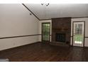 Bright living room with vaulted ceiling, brick fireplace, and hardwood floors at 3857 Pointers Sw Way, Conyers, GA 30094