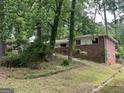 Brick home nestled among mature trees, offering privacy and a serene atmosphere at 1283 Bramble Ne Rd, Atlanta, GA 30329