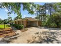 Brick home with a porte cochere, well-maintained lawn, trimmed shrubs, and driveway at 315 Burke Cir, Mcdonough, GA 30253