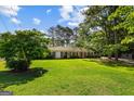 Inviting brick ranch home featuring a well-manicured lawn and classic black shutters at 315 Burke Cir, Mcdonough, GA 30253
