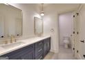 Well-lit bathroom featuring double sinks, quartz countertop, and modern gold fixtures at 1947 Clark Dr, Tucker, GA 30084
