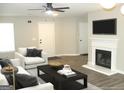 Inviting living room with modern fireplace, television, and neutral-toned furnishings at 4383 Chestnut Lake Ave, Lithonia, GA 30038