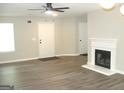 Spacious living room featuring modern floors, a fireplace, and lots of natural light at 4383 Chestnut Lake Ave, Lithonia, GA 30038