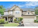 Charming two-story home with a well-manicured lawn, beautiful landscaping and a two car garage at 230 Haleys Ct, Woodstock, GA 30188