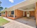 Attached brick carport featuring classic columns, convenient access to the home, and ample parking space at 3548 Meadowview Ct, Rex, GA 30273