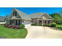 Beautiful brick home with attached garage, pristine lawn, and well-maintained landscaping at 127 Laurel Springs Dr, Mcdonough, GA 30253