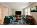 Bright living room featuring comfortable seating, a large window, and a stylish rug at 1851 Grove Way, Hampton, GA 30228