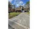 A view of the home with a long driveway leading to an attached garage at 2884 Mountbery Dr, Snellville, GA 30039