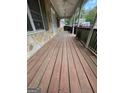 Spacious wooden front porch with white railings and ceiling fans at 2884 Mountbery Dr, Snellville, GA 30039