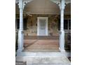 Inviting front porch with stone facade, white pillars, and a decorative railing at 2884 Mountbery Dr, Snellville, GA 30039
