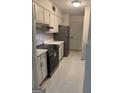 The kitchen is equipped with modern appliances and freshly painted white cabinets at 2968 Par Lorraine, Lithonia, GA 30038