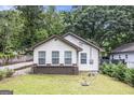 Charming bungalow featuring a well-manicured lawn and three windows that enhance the facade at 523 Mount Zion, Hapeville, GA 30354