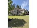 Elegant two-story home with brick facade, mature trees, and meticulously maintained lawn at 2360 Barrington Trace Sw Cir, South Fulton, GA 30331