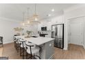 Modern kitchen featuring a large center island with pendant lighting and stainless steel appliances at 3349 Verdi Ln, Kennesaw, GA 30144