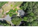 An aerial view of a charming home nestled among lush greenery with a private driveway and well-maintained lawn at 3600 Goldenrod Dr, Alpharetta, GA 30005