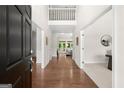 Inviting foyer with gleaming hardwood floors, soaring ceilings, and a view to the light-filled living spaces at 3600 Goldenrod Dr, Alpharetta, GA 30005