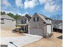 Beautiful brick home with a two-car garage, covered entry, and well-manicured lawn at 10736 Southwood Dr, Hampton, GA 30228