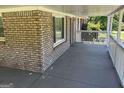 Covered porch featuring brick and painted white wooden posts at 3551 Skyline Sw Ter, Marietta, GA 30008