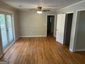 Well-lit living room with hardwood floors, fresh paint, ceiling fan and access to the covered porch at 3551 Skyline Sw Ter, Marietta, GA 30008