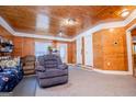 Comfortable living room featuring wood paneled walls, carpet and comfortable seating at 258 Big Oak Rd, Whitesburg, GA 30185