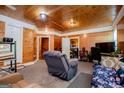 Cozy living room featuring wood paneled walls, carpet and a comfortable recliner and sofa at 258 Big Oak Rd, Whitesburg, GA 30185