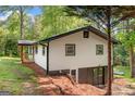 Exterior view of house with a finished basement and sprawling green yard at 474 Upper Burris Rd, Canton, GA 30114