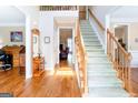Inviting foyer featuring hardwood floors and a grand staircase leading to the upper level at 165 Longshore Way, Fayetteville, GA 30215