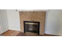 Living room featuring a brick fireplace with black metal screen at 2916 Memorial Se Dr, Atlanta, GA 30317