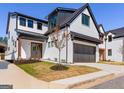 Beautiful two-story home with a white painted brick exterior, black trim and a two-car garage at 1240 Hayes Sq, Peachtree City, GA 30269