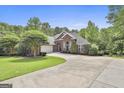 Attractive brick home with manicured lawn, two-car garage, and ample driveway space at 135 Rockglen Ct, Fayetteville, GA 30215