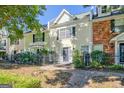 Exterior view of the townhomes with a beautiful landscaped yard, walkway, and a black fence at 488 N Jeff Davis Dr, Fayetteville, GA 30214