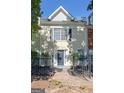 Close exterior of townhome with stucco finish, black shutters, and manicured front yard at 488 N Jeff Davis Dr, Fayetteville, GA 30214