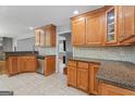 Well-lit kitchen featuring granite countertops, stainless steel appliances, tiled backsplash, and wood cabinets at 23 Hunting Creek Dr, Marietta, GA 30068